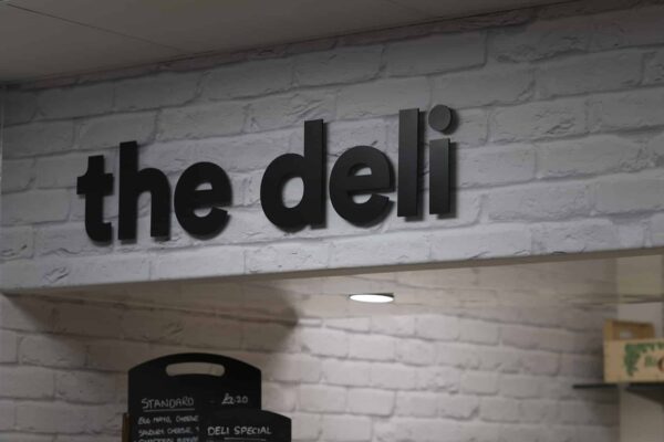 Interior cafe sign 'The Deli' in black letters
