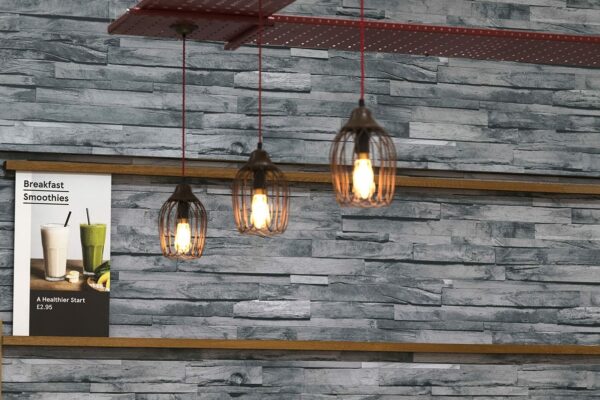 Grey slate effect wallcovering with three lights hanging down in front